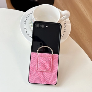 Pink crocodile pattern case for Z Flip with silver ring stand on white table