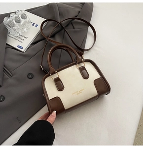 Detail of contrast stitching and FASHION & BAGS lettering on the bowling-style handbag