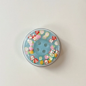 Close-up of a blue glittery fruit-themed magnetic phone grip with colorful fruit slices