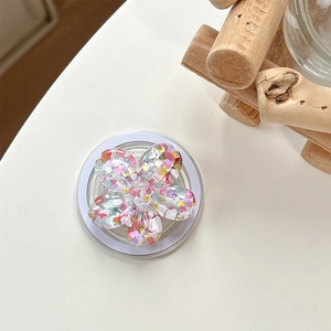 Close-up of a floral Magsafe phone grip with colorful heart sequins and glitter details