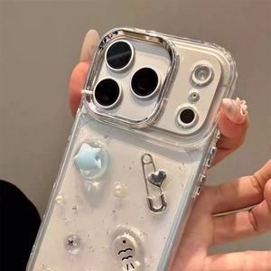 Detail of clear iPhone case with 3D blue stars, silver heart pins and white pearls