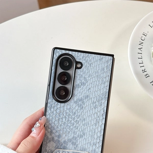 Detailed macro view of gray-blue faux crocodile texture on foldable smartphone case