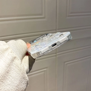 Close-up of clear phone case with 3D water drops and silver glitter on side ports