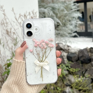 Clear iPhone case with pink dried flowers, white ribbon bow and glitter sequins