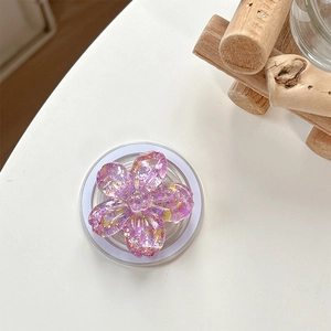 Detail of a 3D cherry blossom phone grip featuring purple resin and gold sequins