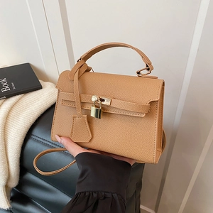 Caramel lychee grain leather handbag with gold padlock and adjustable shoulder strap