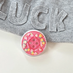 Detail of pink fruit glitter phone grip with strawberry and pineapple motifs