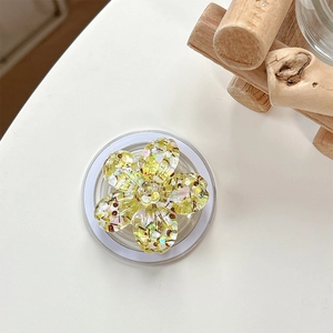 Detail showing a yellow resin cherry blossom phone socket with glitter and sequins