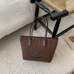 Large brown leopard print tote bag with embossed logo and slim leather shoulder straps