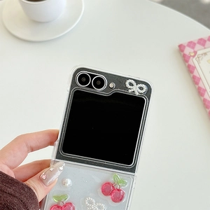 Detail of glitter phone case for Samsung Galaxy Z Flip with 3D cherry and pearl bow charms