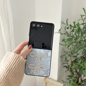 Detail of blue snake leather phone case with rhinestone bows for folding smartphones