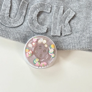 Detailed view of the strawberry and lemon fruit glitter buttons phone grip stand