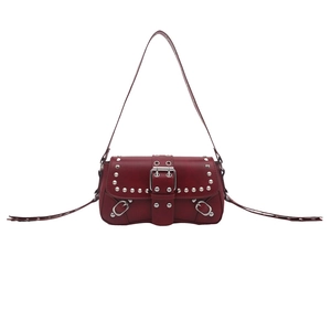 Deep red punk Y2K shoulder bag with silver studs and buckle on white background