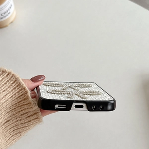 Detail of white crocodile texture phone case with sparkling rhinestone butterfly ornaments