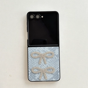 Detail of blue lace phone case for Samsung Z Flip with sparkling rhinestone butterflies