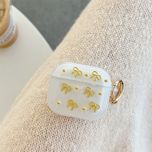 Custodia per AirPods 4 bianca glitterata con fiocchi dorati e gancio in metallo chic