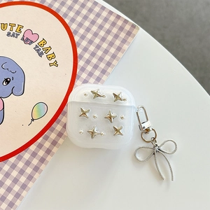 Detail of glitter AirPods case with silver star studs and metallic bow keychain charm