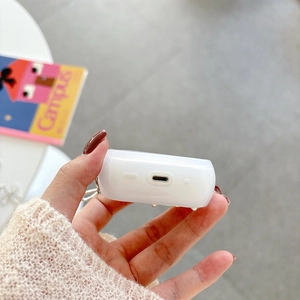 Close-up of translucent white silicone AirPods case with precise bottom speaker cutouts