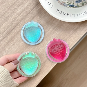 Close-up of glittery strawberry magnetic phone grips in blue, pink and green