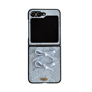 Light blue faux snakeskin leather folding phone case with ribbons and golden metal plaque