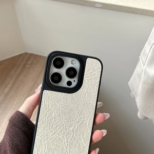 Detail view of the elegant wrinkled leather texture and precise lens cutout on iPhone case