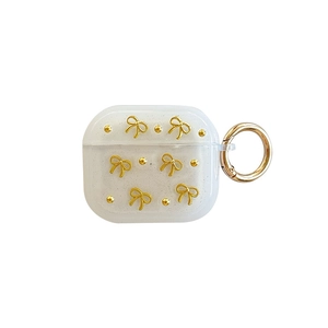 Custodia AirPods bianco crema glitterata con fiocco dorato 3D e gancio in metallo rotondo