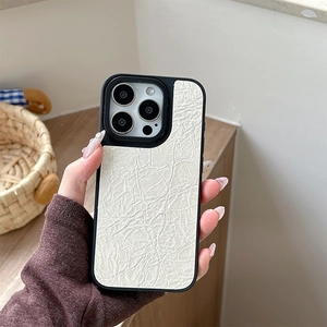 Detailed view of white crinkled leather phone case with black frame on iPhone Pro series
