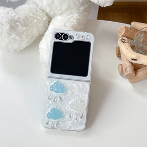 Detail of Galaxy Z Flip case featuring 3D cloud charms and pearl embossed texture