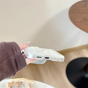 Close-up of precise speaker and charging port cutouts on a floral pearl phone case