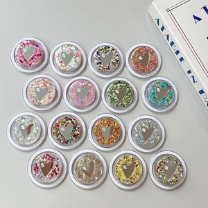 Collage of 16 colorful round sequin heart mirrors with retractable phone grip stands