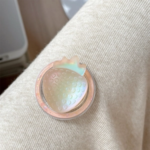 Detail of strawberry phone grip with iridescent resin texture on a soft knit background