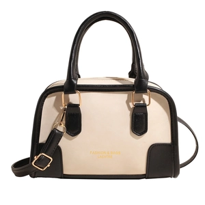 Elegant white and black Boston handbag with golden hardware and adjustable shoulder strap