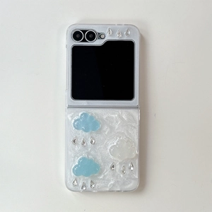 Detail of 3D cloud and rhinestone ornaments on a textured white foldable phone case