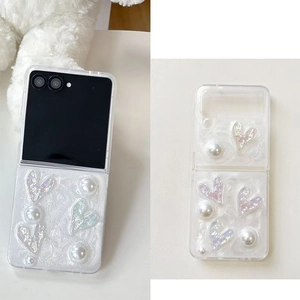 Detail of folding phone case with 3D iridescent hearts, pearls and ripple texture