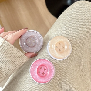 Glittery button-style expandable phone grip socket set in pink, gold, and purple colors