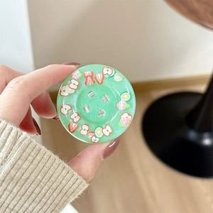 Close-up of mint green glitter phone socket featuring various colorful fruit slices