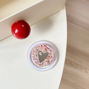 Detail of glitter sequins and heart mirror element on the foldable phone stand holder