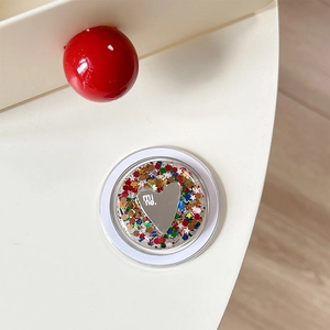Detail of glitter sequins and heart mirror design on the collapsible phone socket stand