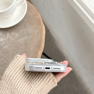 Detailed view of precise charging port and speaker cutouts on glitter clear phone case