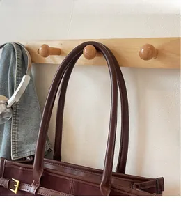 Detail of vintage large capacity baguette bag with smooth leather strap and metal buckle