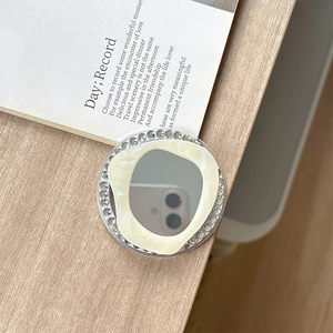 Macro detail of magnetic phone grip with rhinestones, mother of pearl inlay, and mirror finish
