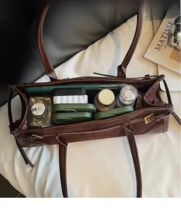Top view of dark brown leather tote bag interior showing ample storage space for essentials
