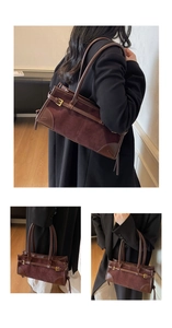Detail of dark brown patchwork tote bag with suede texture and gold buckle accents