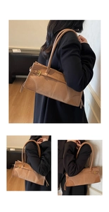Detail of vintage brown baguette bag featuring textured suede and smooth leather stitching