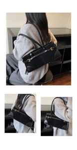 Close-up of black baguette bag featuring vintage metal buckles and mixed leather textures