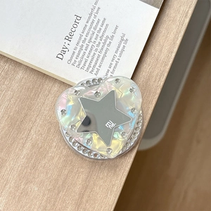 Macro shot of heart-shaped magnetic phone grip with rhinestones and holographic finish