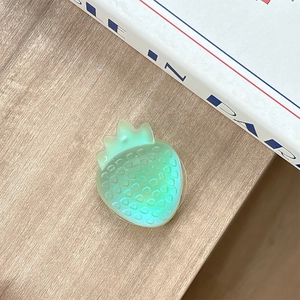 Macro shot of translucent green strawberry phone socket with realistic seed texture