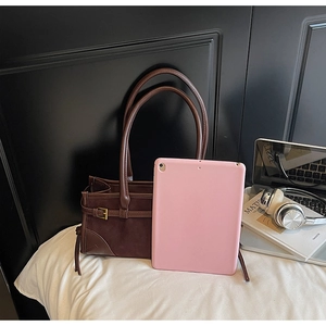 Brown tote bag displaying spacious interior capacity with laptop and daily essentials