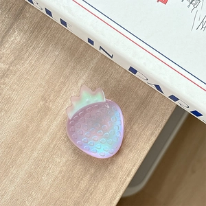 Macro detail of a colorful gradient resin strawberry phone grip with a translucent finish