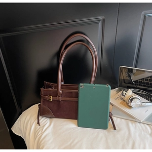 Detail view of large dark brown tote bag interior capacity with a tablet reference